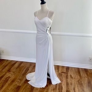 White gown with silver cut out.